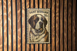 A postage stamp featuring a Saint Bernard dog, with the text "SAINT BERNARD 20c" printed on it.