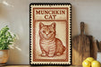 a framed illustration of a cat, with a wooden cutting board and a potted plant to the left.