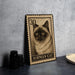 A metal stamp featuring a close-up of a Siamese cat's face, with the text "BIRMAN CAT" printed on it.