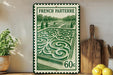 A French postage stamp featuring a garden scene, with a potted plant and kitchen utensils visible in the foreground.