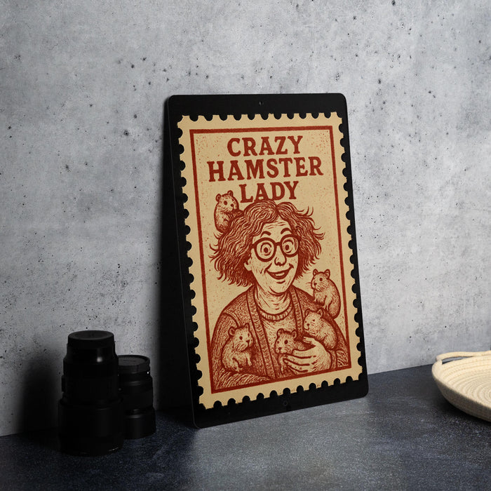 a framed poster with a cartoon illustration of a woman holding a hamster, accompanied by the text "Crazy Hamster Lady".