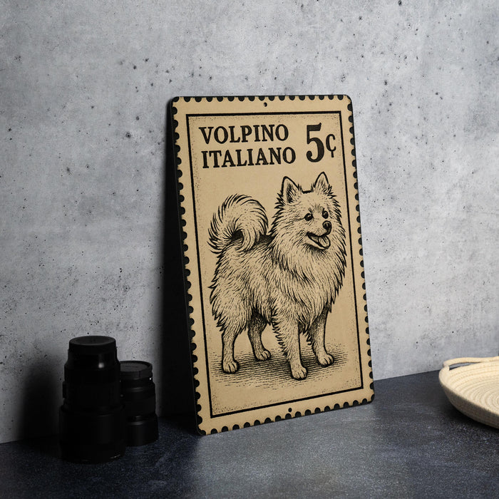 A vintage-style metal stamp featuring an illustration of a fluffy dog, with the text "VOLPINO ITALIANO 5¢" printed on it.