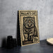 A wooden postcard featuring a cat illustration, with the text "PALLAS'S CAT" and a value of 70 cents.