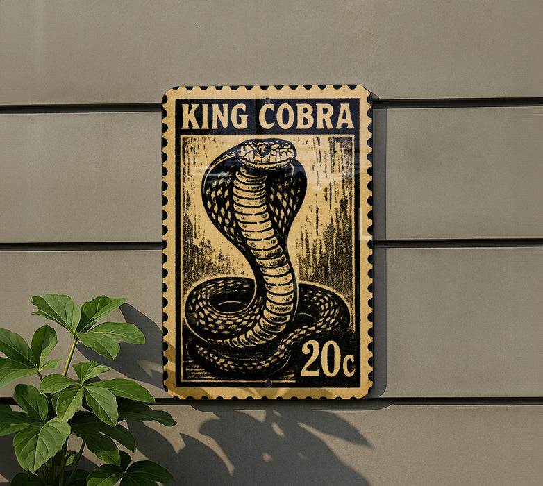 A King Cobra postage stamp is displayed on a wall, with a plant visible to the left.
