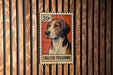 A metal stamp featuring an illustration of an English foxhound dog.