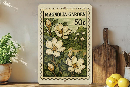 A framed print of a magnolia flower stamp is displayed on a shelf, surrounded by kitchen utensils and a potted plant.