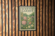 a sign that reads "Scented Garden" with a floral illustration of roses, daisies, and other flowers.