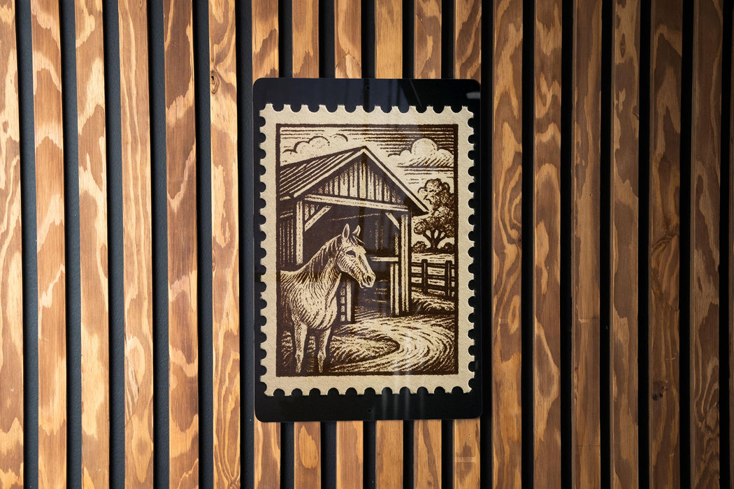 A wooden wall with a black and white illustration of a horse standing in front of a barn.