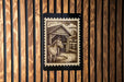 A wooden wall with a black and white illustration of a horse standing in front of a barn.