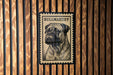 A bull mastiff dog is depicted on a wooden surface, with a postage stamp-like design above it.