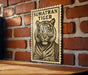a wooden table with a framed poster of a tiger on it, mounted on a brick wall.