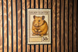 A postage stamp featuring a golden hamster, with the text "GOLDEN HAMSTER" and "50c" printed on it.