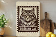 A wooden shelf displaying a framed image of a Siberian cat, a potted plant, a wooden cutting board, and some lemons.