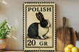A decorative sign featuring a black and white rabbit, with the text "POLISH 20 GR" printed on it. The sign is placed on a wooden surface, with a potted plant and a wooden cutting board nearby.