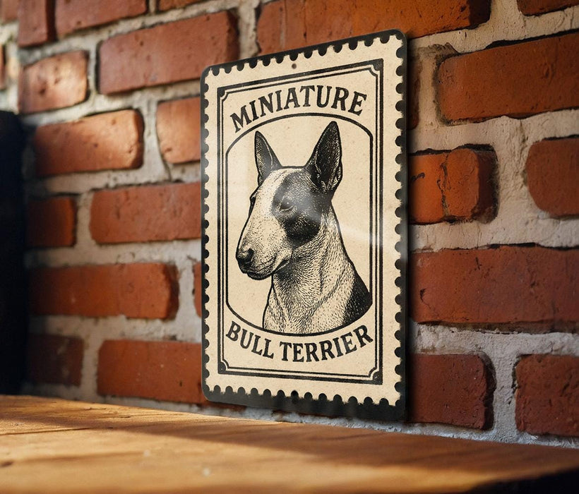 a bull terrier, a small and muscular breed of dog, with a vintage-style metal sign displaying the breed's name and image.
