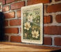 A vintage-style magnolia garden postage stamp is displayed on a brick wall, featuring a floral illustration of magnolia flowers.
