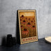 A metal sign with a floral design and the text "ECHINACEA" is displayed on a table, accompanied by a stack of black camera lenses and a white dish.