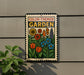 A metal sign with a colorful illustration of flowers and plants, mounted on a wall.