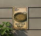 A metal sign with a wicker basket on it, mounted on a wall.