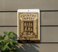 a sign for a country pantry, with a pantry door open and various food items displayed inside.