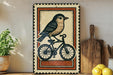 a decorative sign with a bird riding a bicycle, placed on a shelf next to a wooden cutting board and some lemons.
