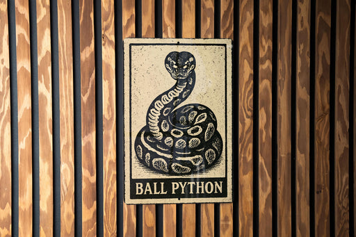 A sign with a snake image and the text "BALL PYTHON" is displayed on a wooden wall.
