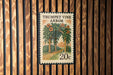 A 20c stamp from the country of Romania, featuring an illustration of a garden with a wooden trellis and flowers.