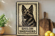 A metal sign featuring a black and white illustration of a German Shepherd dog, with the text "SHILOH SHEPHERD" below the image.