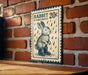 A sign on a brick wall that reads "RABBIT 20¢ IN RAIN BOTS" with an illustration of a rabbit wearing rain boots.