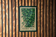 A green and white sign with a plant illustration is mounted on a wooden wall.