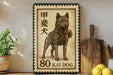 A framed stamp depicting a dog, specifically a kai dog, is displayed on a shelf next to a wooden cutting board and some lemons.