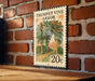 A metal sign with a floral illustration and the text "TRUMPET VINE ARBOR" is mounted on a brick wall.