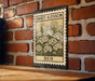 A vintage-style metal sign with a floral design is mounted on a brick wall, featuring the text "SWEET ALYSSUM BED".