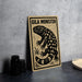a wooden sign with a black and white illustration of a gila monster, a type of lizard, on a beige background.