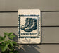 A sign with a graphic of hiking boots mounted on a wall, with the text "HIKING BOOTS" below the boots.