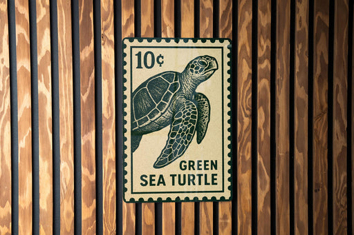 A green sea turtle stamp is displayed on a wooden wall.