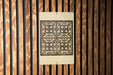 a decorative tile pattern on a wooden wall.