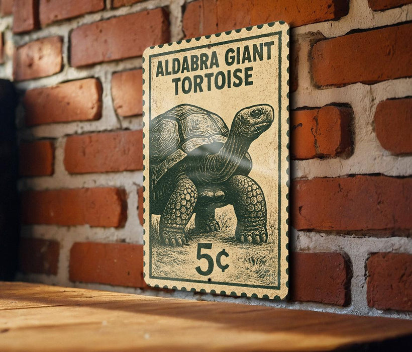 A vintage postage stamp featuring a large tortoise, with the text "ALDABRA GIANT TORTOISE" and the denomination "5c".