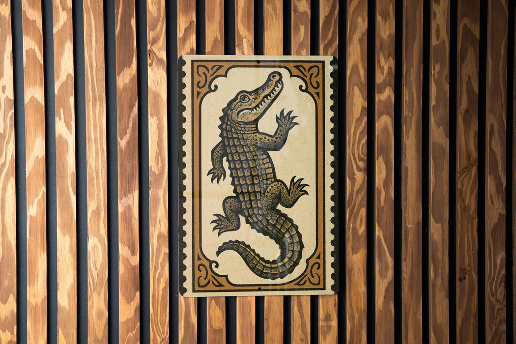a large, detailed illustration of a crocodile or alligator, which is the central focus of the image.