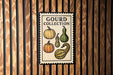 A poster with the title "Gourd Collection" and illustrations of various gourds is displayed on a wooden wall.