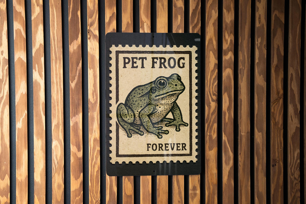 A sign with a stamp-like design featuring a frog, mounted on a wooden wall.