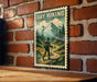 A vintage-style metal sign with a hiker walking through a forest, mounted on a brick wall.