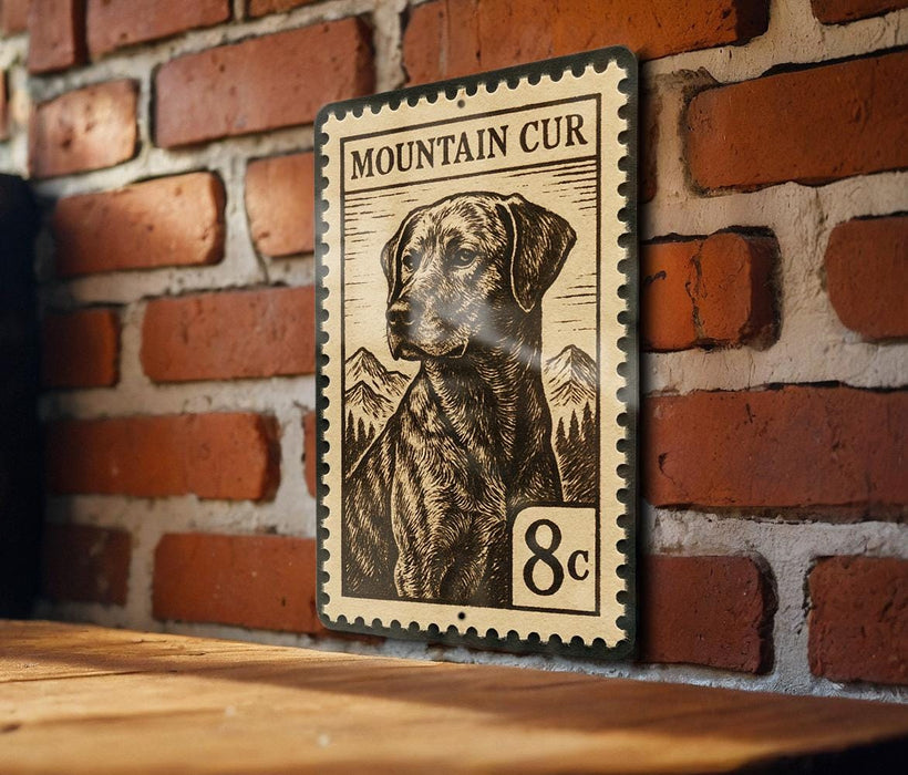 A metal sign with a dog illustration and the text "MOUNTAIN CUR" is mounted on a brick wall.
