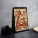 A framed illustration of a rabbit and a baby rabbit, with the text "BUNNY MOM" on the frame, is displayed on a table.