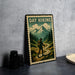 A metal sign with a vintage-style illustration of a hiker walking on a trail through a mountainous landscape, with the text "DAY HIKING" prominently displayed.