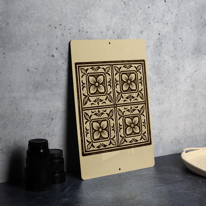a decorative tile design on a beige background, placed on a countertop next to a stack of black containers.