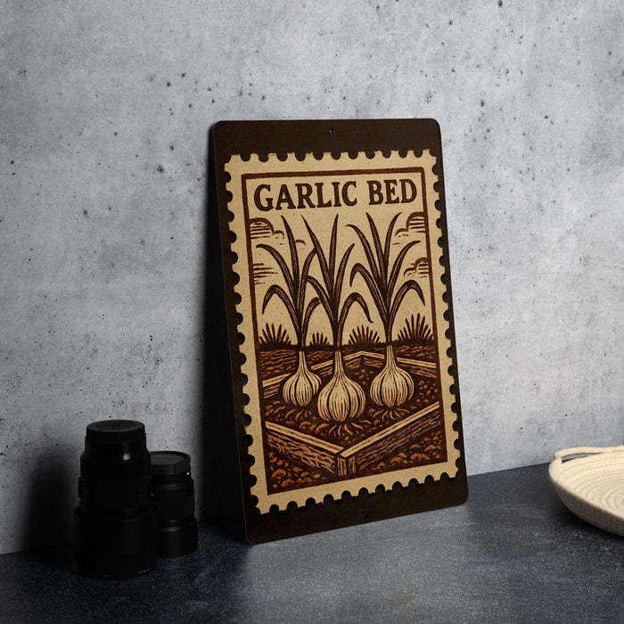 A wooden sign with the text "GARLIC BED" and an illustration of garlic bulbs is displayed on a table.