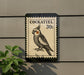 A postage stamp featuring a cockatoo, with the text "COCKATIEL 30c" printed on it.