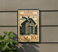 A vintage-style stamp depicting a stone smokehouse, mounted on a wall.