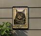 A Maine Coon cat illustration on a wall, with the text "MAINE COON" below the image.